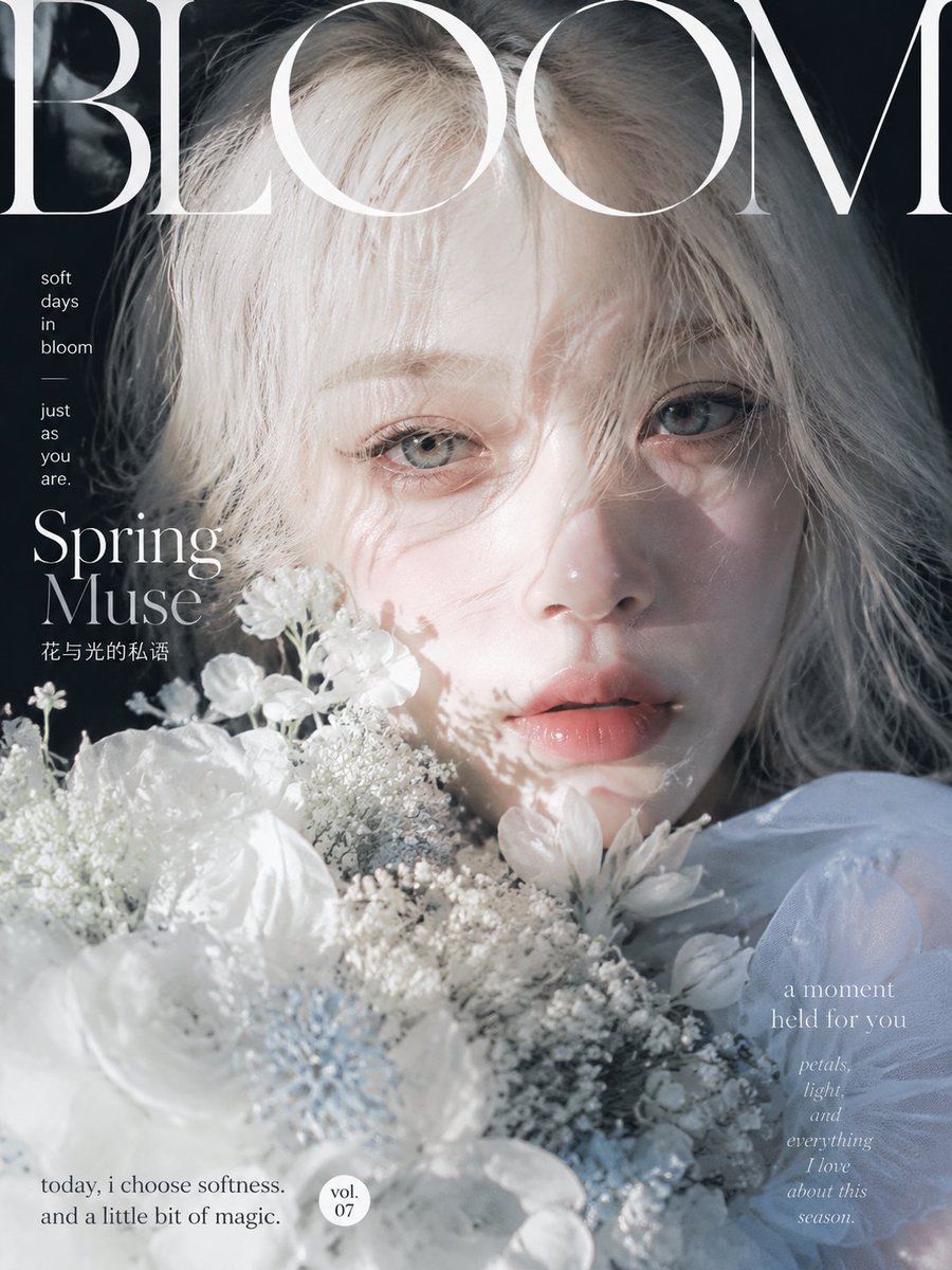 A frontal close-range portrait with a white bouquet filling the lower left, under a giant overlapping masthead. Raking daylight and a cool blue and silver…